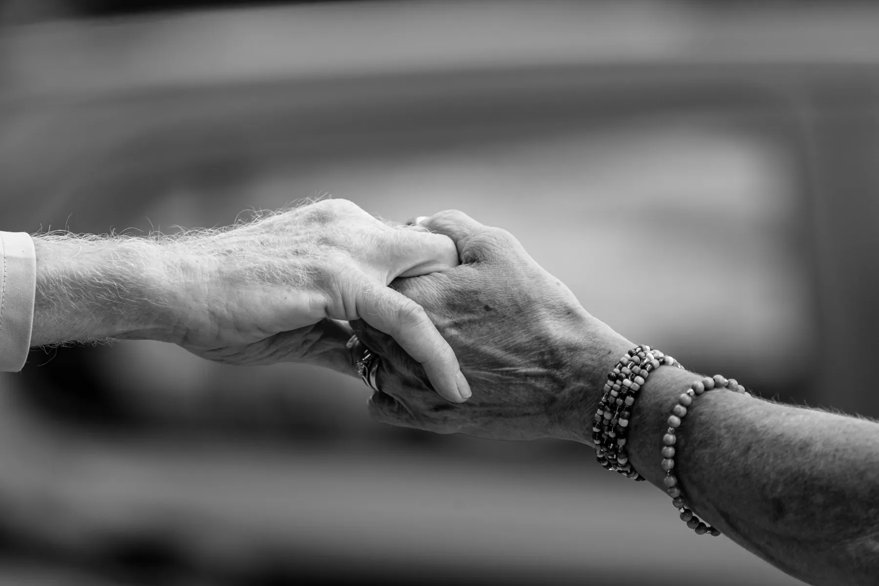 Two people holding hands in comfort